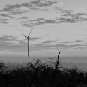 A view of a windmill at sunrise